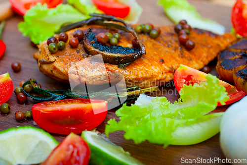 Image of wood fired hoven cooked chicken breast on wood board