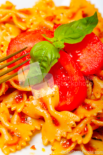 Image of Italian pasta farfalle butterfly bow-tie and tomato sauce