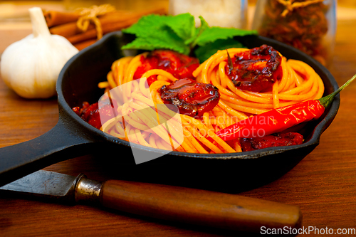 Image of italian spaghetti pasta and tomato with mint leaves