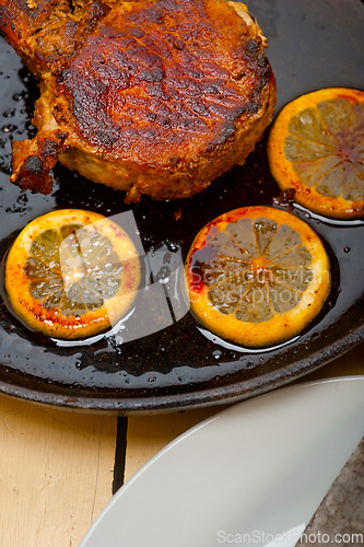 Image of pork chop seared on iron skillet
