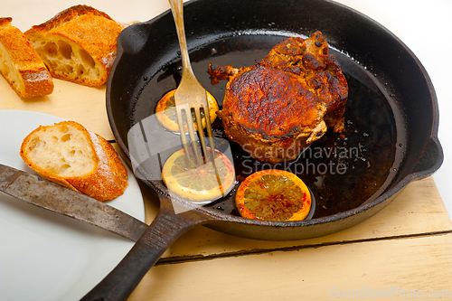 Image of pork chop seared on iron skillet