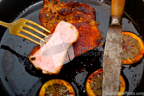 Image of pork chop seared on iron skillet