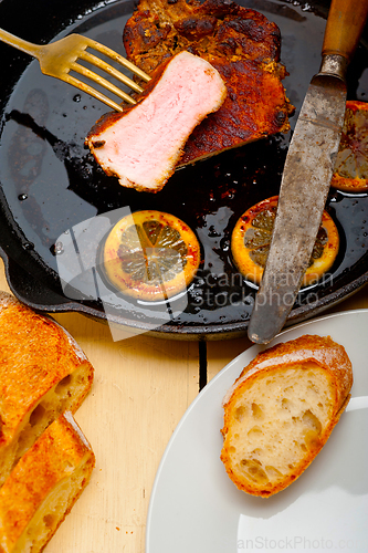 Image of pork chop seared on iron skillet