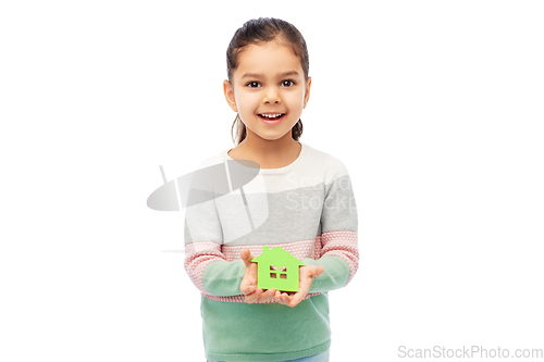 Image of smiling little girl holding green house icon