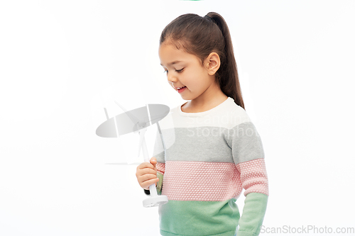 Image of smiling girl with toy wind turbine