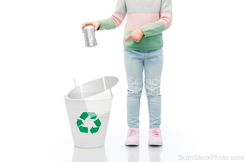 Image of girl throwing tin can into rubbish bin