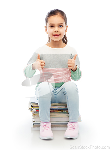 Image of smiling girl with magazines sorting paper waste