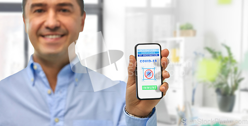 Image of man with certificate of vaccination on smartphone