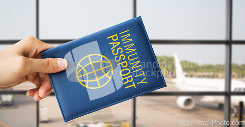 Image of close up of hand holding immunity passport