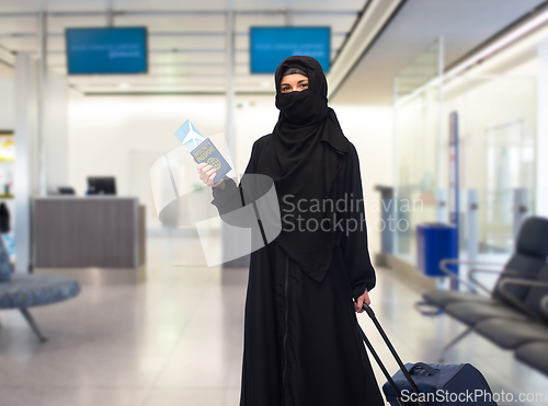 Image of muslim woman with ticket, immune passport and bag