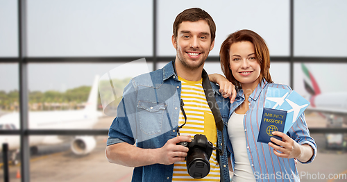 Image of couple with tickets, immunity passport and camera