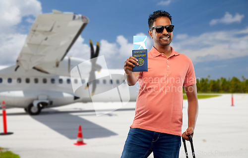 Image of happy man with air ticket and immunity passport