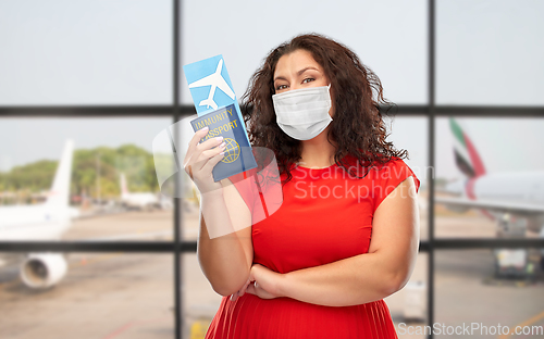 Image of woman in mask with immunity passport and ticket