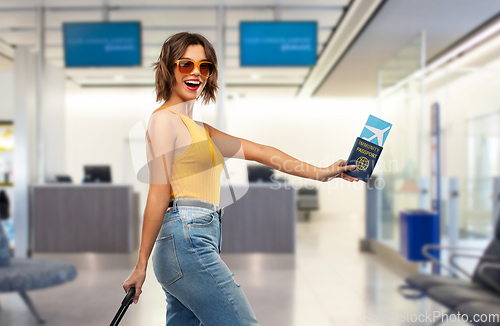 Image of happy woman with air ticket and immunity passport