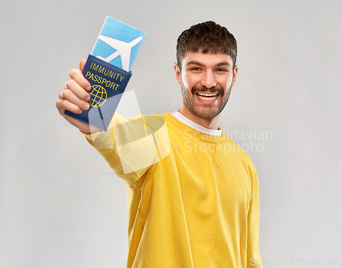 Image of smiling man with air ticket and immunity passport