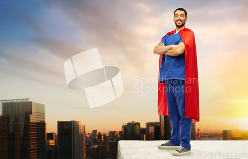 Image of doctor or male nurse in superhero cape in city
