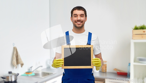 Image of male cleaner with chalkboard at at kitchen