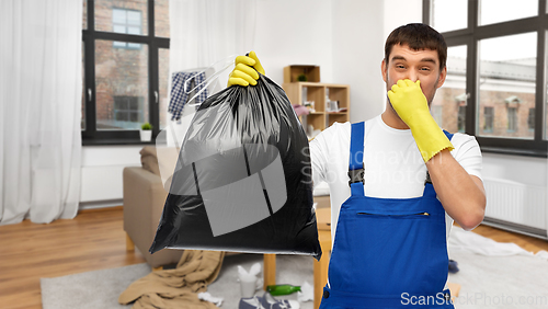 Image of male worker or cleaner with garbage bag at home