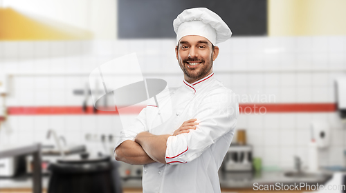 Image of happy smiling male chef at restaurant kitchen