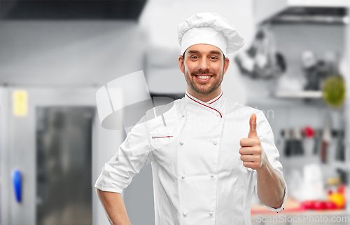 Image of smiling male chef in toque showing thumbs up