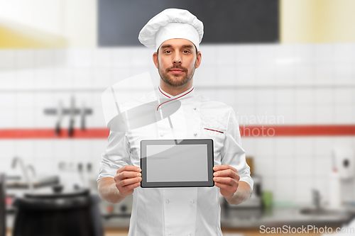 Image of male chef showing tablet pc at restaurant kitchen
