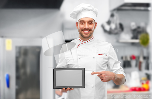 Image of male chef showing tablet pc at restaurant kitchen