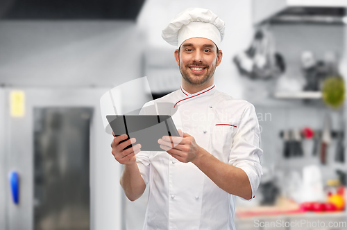 Image of male chef with tablet pc at restaurant kitchen