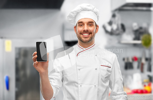 Image of happy smiling male chef showing smartphone