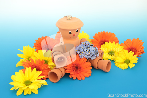 Image of Flowerpot Man Garden Ornament and Summer Flowers