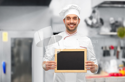 Image of happy smiling male chef showing chalkboard