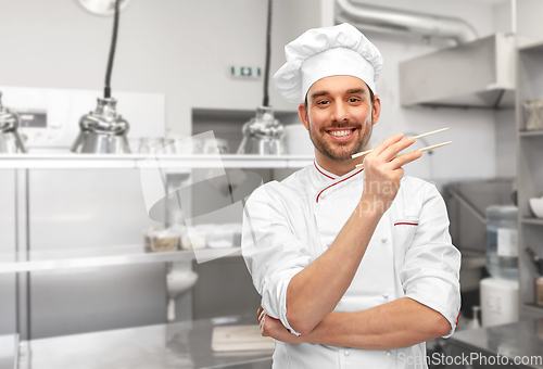 Image of happy smiling male chef with chopsticks