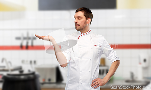 Image of male chef holding something on hand