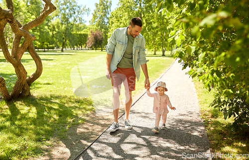 Image of happy father with baby daughter walking at park