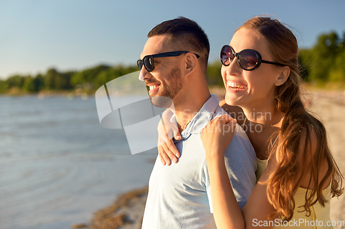 Image of happy couple hugging on summer beach