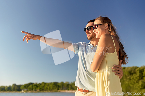 Image of happy couple hugging on summer beach