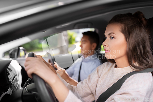 Image of car driving school instructor teaching woman