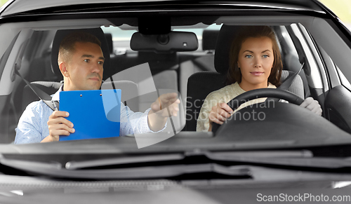 Image of car driving school instructor and young driver