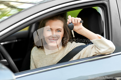 Image of woman or female driver with car key in city