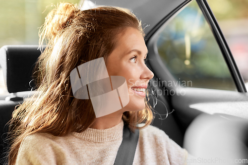 Image of happy smiling woman or female passenger in car