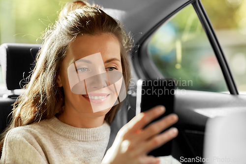 Image of woman in car using smartphone