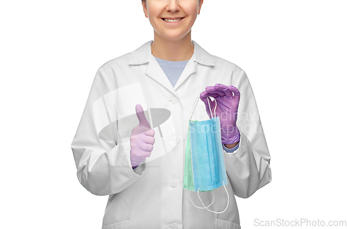Image of smiling doctor with two masks showing thumbs up