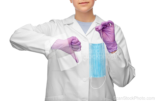 Image of female doctor with mask showing thumbs down