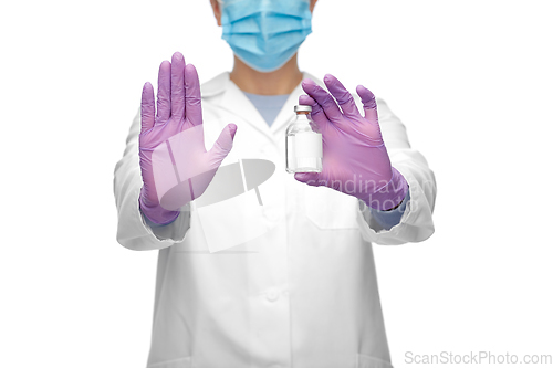 Image of close up of doctor with syringe shows stop gesture