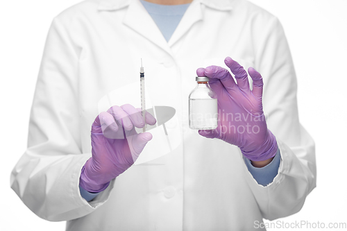Image of close up of doctor with medicine and syringe