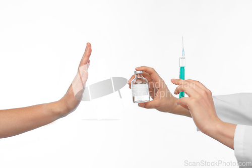 Image of hand with medicine and showing stop gesture