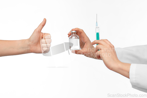 Image of hand with medicine and showing thumbs up