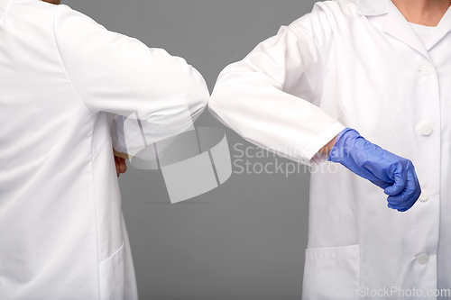 Image of close up of doctors make elbow bump gesture