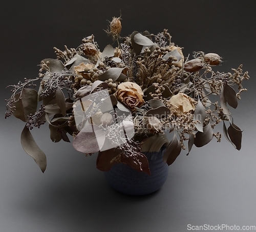 Image of bouquet of dried flowers in ceramic vase
