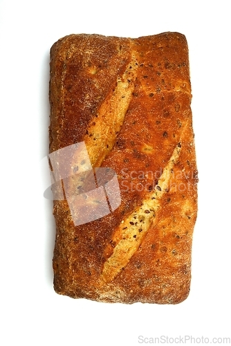 Image of loaf of bread with seeds on white background