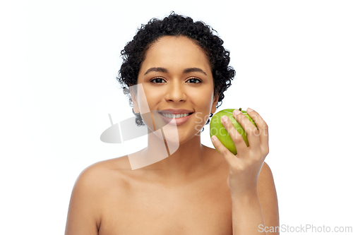 Image of happy african american woman holding green apple